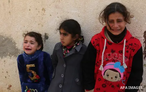 Relatives of Palestinian Policeman Major Abdul Hamid al-Ekar, who suffocated to death while in a cross-border tunnel under Gaza's frontier with Egypt, mourn during his funeral in Rafah in the southern Gaza Strip, on Febr...