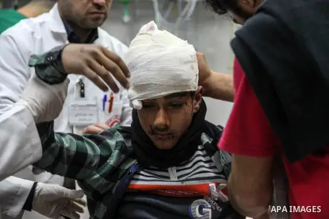Paramedics treat a Palestinian boy, who was injured by Israeli security force during a protest near the Israeli settlement of Kibbutz Zikim, at a hospital in Jabalia in the northern Gaza strip on February 12, 2019. Pales...