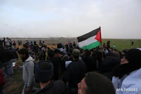 Palestinian protesters gather during clashes with Israeli troops in tents protest where Palestinians demand the right to return to their homeland at the Israel-Gaza border, in Khan Younis in the southern Gaza Strip, on F...