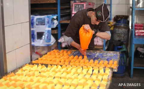 Palestinian workers prepare a traditional sweets and sugar candy in the sweet factory in Gaza city on February 19, 2019. Photo by Mahmoud Ajjour