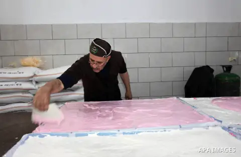 Palestinian workers prepare a traditional sweets and sugar candy in the sweet factory in Gaza city on February 19, 2019. Photo by Mahmoud Ajjour
