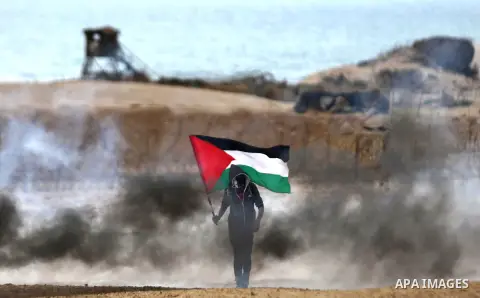 Palestinian demonstrators protest on the beach along the northern Gaza border, across from the Israeli settlement of Kibbutz Zikim, on February 19, 2019, as part of weekly maritime protests against the naval blockade of...