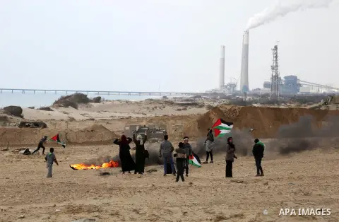 Palestinian demonstrators protest on the beach along the northern Gaza border, across from the Israeli settlement of Kibbutz Zikim, on February 19, 2019, as part of weekly maritime protests against the naval blockade of...