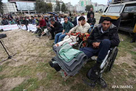 Wounded Palestinians take part in a protest against cutting their salaries by Palestinian president Mahmoud Abbas, in Gaza city on March 13, 2019. Photo by Mahmoud Ajjour