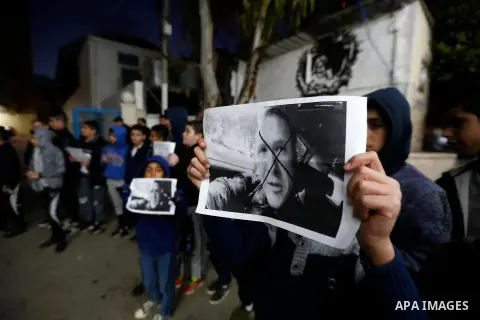 Palestinians hold banners as they participate in a protest against Friday's mass shootings in New Zealand, in the West Bank city of Bethlehem on March 17, 2019. The live-streamed attack by an immigrant-hating white natio...