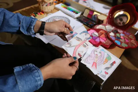 Palestinian artist Najat Abu Yusuf, 20, paints artworks with makeup, at her house in Khan Younis in the southern Gaza strip, on March 19, 2019. Painting with makeup is a fun and cost-effective alternative to exploring yo...