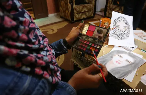 Palestinian artist Najat Abu Yusuf, 20, paints artworks with makeup, at her house in Khan Younis in the southern Gaza strip, on March 19, 2019. Painting with makeup is a fun and cost-effective alternative to exploring yo...