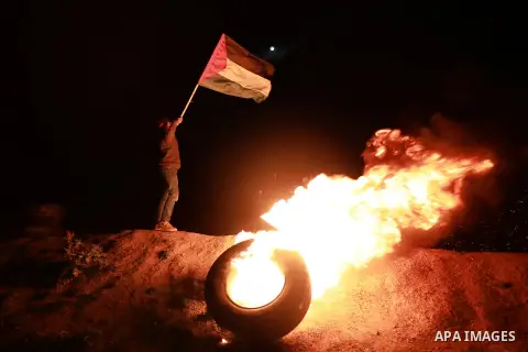 Palestinian protesters calling themselves the "night confusion units", burn tires as they gather near the Gaza-Israel border east of Gaza city, March 20, 2019. Hundreds of Palestinian protesters, have been organizing, as...