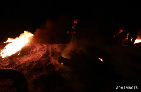 Palestinian protesters calling themselves the "night confusion units", burn tires as they gather near the Gaza-Israel border east of Gaza city, March 20, 2019. Hundreds of Palestinian protesters, have been organizing, as...