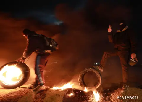 Palestinian protesters calling themselves the "night confusion units", burn tires as they gather near the Gaza-Israel border east of Gaza city, March 20, 2019. Hundreds of Palestinian protesters, have been organizing, as...