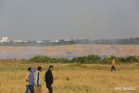 Palestinian protesters clash with Israeli troops following the tents protest where Palestinians demand the right to return to their homeland at the Israel-Gaza border, in Khan Younis in the southern Gaza Strip, March 22,...