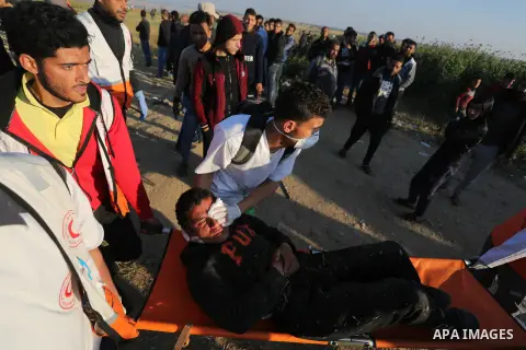 A wounded Palestinian protester is evacuated during clashes with Israeli troops following the tents protest where Palestinians demand the right to return to their homeland at the Israel-Gaza border, in Khan Younis in the...