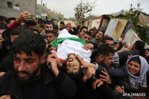 Mourners carry the body of Palestinian Habib Al Masry, 24, who was shot dead by Israeli forces during clashes with Israeli troops in tents protest where Palestinians demand the right to return to their homeland at the Is...