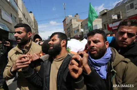 Mourners carry the body of Palestinian Bilal al-Najjar, 17, who was shot dead by Israeli forces at the Israel-Gaza border, during his funeral in Khan Younis in the southern of Gaza strip, on March 31, 2019. Photo by Ashr...