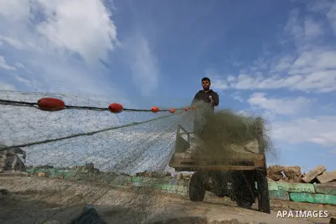 Palestinian fishermen work on their fishing boats, at Gaza seaport, on April 2, 2019. Israel decided to expand the allowed fishing area to 6 nautical miles in northern Gaza Strip, 12 miles in central Gaza Strip and 15 mi...