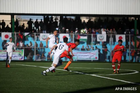 Etihad Khan Younis (Orange) and Hebron Youths (white) teams competi during the final match in Tokyo cup for youths, at Rafah staduim, in the southern Gaza strip, April 10, 2019. Etihad Khan Younis team won the Tokyo Cham...