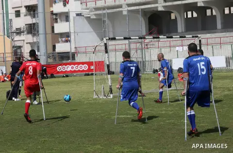 Palestinian amputees using crutches play a football match during the first football tournament for amputees, at Palestine Stadium in Gaza city, on April 13, 2019. More than 125 have had amputations shot by Israeli forces...