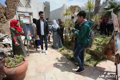 Palestinians attend the opening of the exhibition "From the Rubble" marking Palestinian Prisoner Day at the Arts and Crafts Village that was damaged in an Israeli airstrike on the Gaza City on April 17, 2019. Photo by Ma...