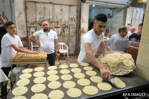 A Palestinian vendor prepares ''Qatayef'', traditional pancakes that are popular during the Muslim fasting month of Ramadan, in Jerusalem on May 12, 2019. Muslims around the world celebrate the holy month of Ramadan by p...