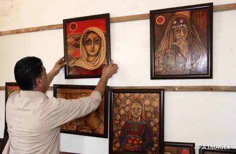 Medical Laboratory specialist Mohamed El Sherif, 54, displays a drawing of burned wood at his house, in Gaza city, on May 16, 2019. El Sherif has drawing talent, take it as a paint since four years, and participat in man...