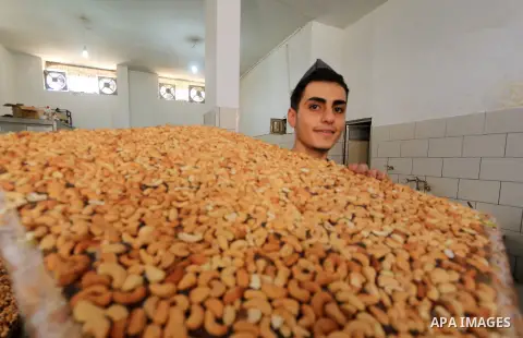 Palestinians prepare sweet known in Arabic as "Halkoum" in a store to be sold ahead of the Eid al-Fitr holiday in Gaza city on May 30, 2019. Eid al-Fitr marks the end of Muslim's holy fasting month of Ramadan when faithf...