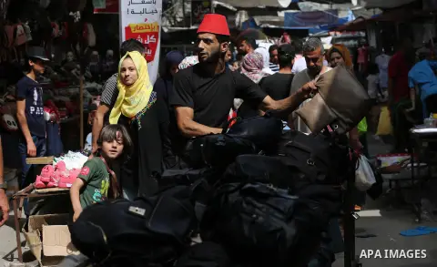 Palestinians shop at a market ahead of Eid al-Fitr holiday, celebrating the end of the holy Muslim fasting month of Ramadan, in Khan Younis in the southern Gaza Strip, June 04, 2019. Photo by Ashraf Amra