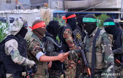 Palestinian militants perform the morning prayer of Eid al-Fitr holiday which marks the end of the Muslim holy month of Ramadan, in Dair Al Balah in the center of Gaza strip on June 5, 2019. Photo by Mahmoud Khattab