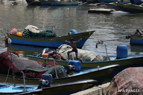 Palestinians swim at Gaza seaport, on June 13, 2019. The Israeli government said late Wednesday that the fishing zone off the coast of Gaza had been closed, in retaliation for the launch of incendiary balloons from the P...