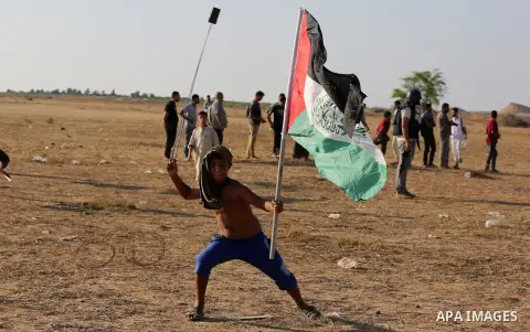Palestinian protesters clash with Israeli troops following the tents protest where Palestinians demand the right to return to their homeland at the Israel-Gaza border, in Khan Younis in the southern Gaza Strip, June 14,...