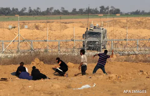 Palestinian protesters clash with Israeli troops following the tents protest where Palestinians demand the right to return to their homeland at the Israel-Gaza border, in Khan Younis in the southern Gaza Strip, June 14,...