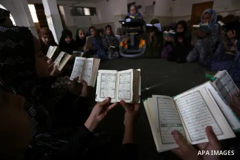 A disabled Palestinian woman, Iman Abu Sabha, 33, gives a class in the memorization of the Holy Quran, during summer vacation at a Mosque, in Khan Younis in the southern of Gaza strip, on June 18, 2019. Photo by Ashraf A...
