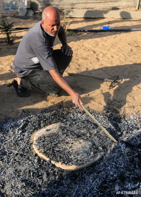 Palestinians prepare Qarsa traditional dish, in Rafah in the southern Gaza Strip, June 19, 2019. Gaza cuisine is Mediterranean-based, relying on olive oil, fresh vegetables, herbs and grains. "The Gaza Kitchen" is being...