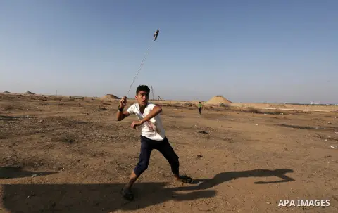 Palestinian protesters clash with Israeli troops following the tents protest where Palestinians demand the right to return to their homeland at the Israel-Gaza border, in Khan Younis in the southern Gaza Strip, June 21,...