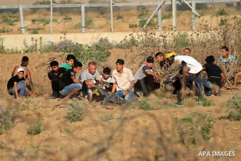 Palestinian protesters clash with Israeli troops following the tents protest where Palestinians demand the right to return to their homeland at the Israel-Gaza border, in the central Gaza Strip, June 21, 2019. Photo by M...