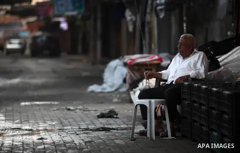 Palestinians walk past closed shops during a general strike against the economic workshop in Bahrain in Gaza city on June 25, 2019. The Palestinian Ministry of Foreign Affairs said “Trump administration is re-producing t...