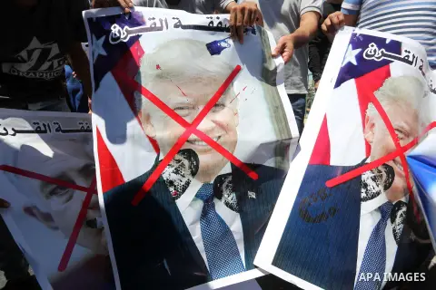 Palestinian protesters shot slogans during a protest against the Bahrain economic workshop, in Khan Younis in the southern of Gaza strip, on June 26, 2019. Kicking off the Trump administration’s international peace confe...
