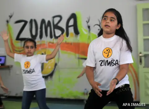 Palestinian children participate in a Zumba class during the summer vacation, at Jalaa Gym, in Gaza city, on June 30, 2019. Zumba is an exercise fitness program created by Colombian dancer and choreographer Alberto "Beto...