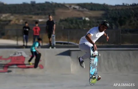 A Palestinian youth skateboards in a skatepark in the village of Asira ash-Shamaliya, near the West Bank city of Nablus, July 02, 2019. Skateboarding is an action sport which involves riding and performing tricks using a...
