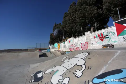 A foreign activist skateboards in a skatepark in the village of Asira ash-Shamaliya, near the West Bank city of Nablus, July 02, 2019. Skateboarding is an action sport which involves riding and performing tricks using a...