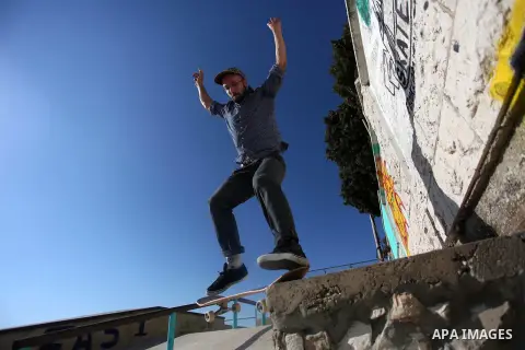 A foreign activist skateboards in a skatepark in the village of Asira ash-Shamaliya, near the West Bank city of Nablus, July 02, 2019. Skateboarding is an action sport which involves riding and performing tricks using a...