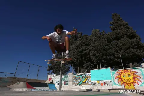 A foreign activist skateboards in a skatepark in the village of Asira ash-Shamaliya, near the West Bank city of Nablus, July 02, 2019. Skateboarding is an action sport which involves riding and performing tricks using a...