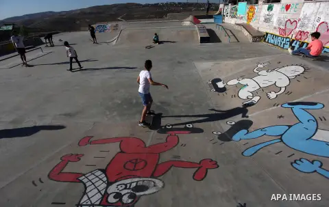 Palestinians and foreign activists skateboard in a skatepark in the village of Asira ash-Shamaliya, near the West Bank city of Nablus, July 02, 2019. Skateboarding is an action sport which involves riding and performing...