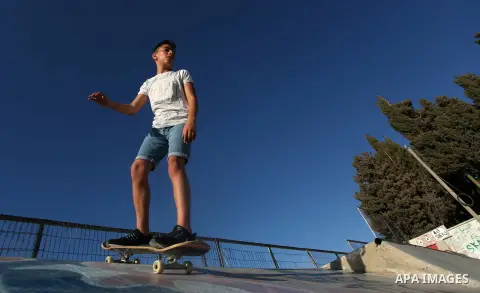 A Palestinian girl skateboards in a skatepark in the village of Asira ash-Shamaliya, near the West Bank city of Nablus, July 02, 2019. Skateboarding is an action sport which involves riding and performing tricks using a...