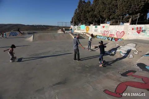 Palestinians and foreign activists skateboard in a skatepark in the village of Asira ash-Shamaliya, near the West Bank city of Nablus, July 02, 2019. Skateboarding is an action sport which involves riding and performing...