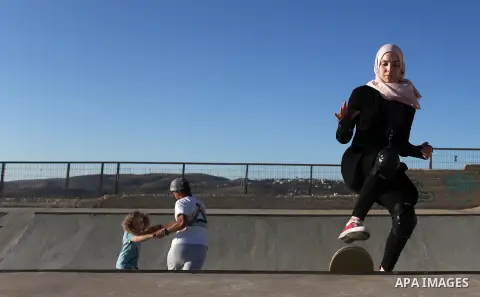 A Palestinian girl skateboards in a skatepark in the village of Asira ash-Shamaliya, near the West Bank city of Nablus, July 02, 2019. Skateboarding is an action sport which involves riding and performing tricks using a...