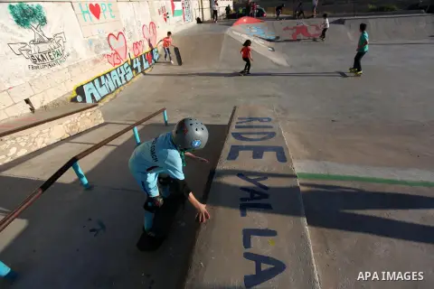 Palestinians and foreign activists skateboard in a skatepark in the village of Asira ash-Shamaliya, near the West Bank city of Nablus, July 02, 2019. Skateboarding is an action sport which involves riding and performing...