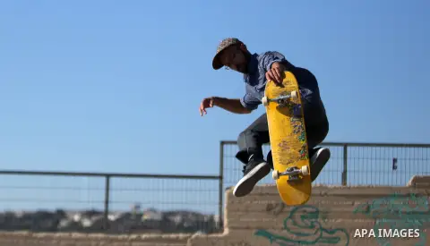 A foreign activist skateboards in a skatepark in the village of Asira ash-Shamaliya, near the West Bank city of Nablus, July 02, 2019. Skateboarding is an action sport which involves riding and performing tricks using a...