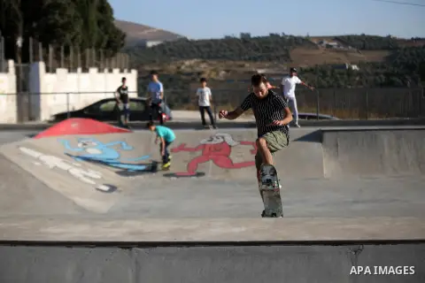 A Palestinian youth skateboards in a skatepark in the village of Asira ash-Shamaliya, near the West Bank city of Nablus, July 02, 2019. Skateboarding is an action sport which involves riding and performing tricks using a...