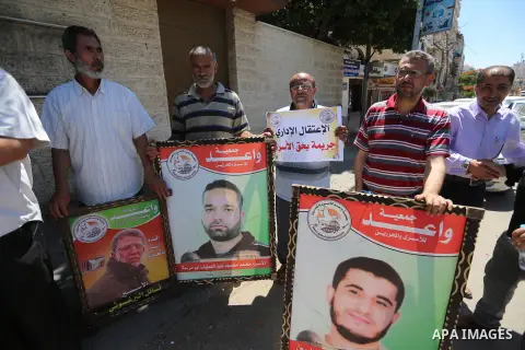 Palestinians hold placards during a protest in solidarity with prisoners on hunger strike against administrative detention, in Gaza city on July 03, 2019. Photo by Ashraf Amra