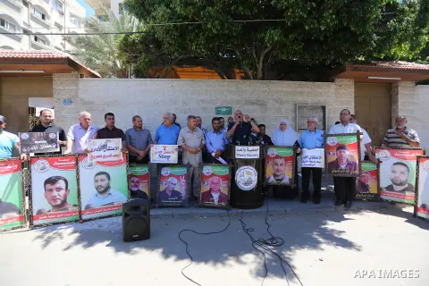 Palestinians hold placards during a protest in solidarity with prisoners on hunger strike against administrative detention, in Gaza city on July 03, 2019. Photo by Ashraf Amra